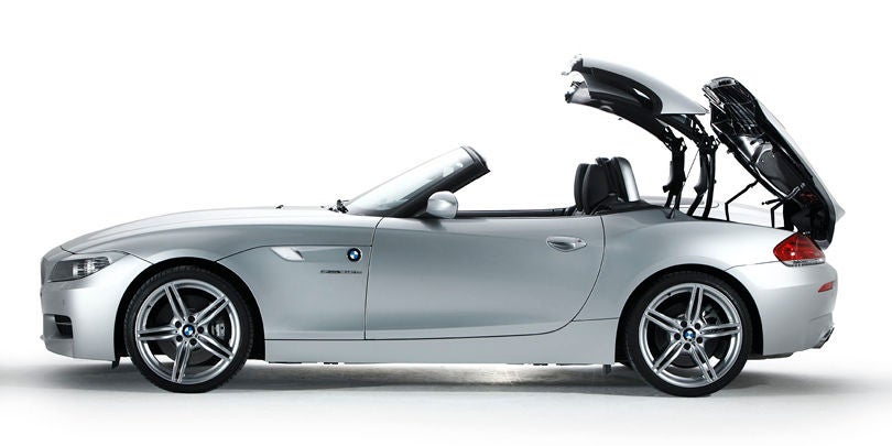 A BMW convertible opening it' roof