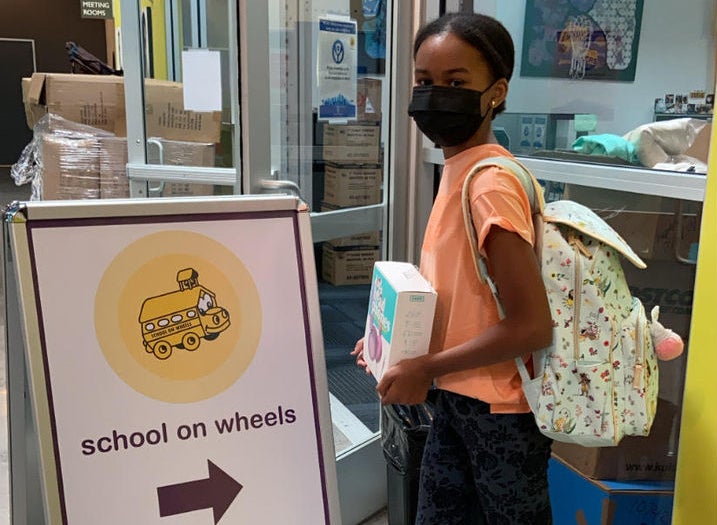 female pupil entering School on Wheels