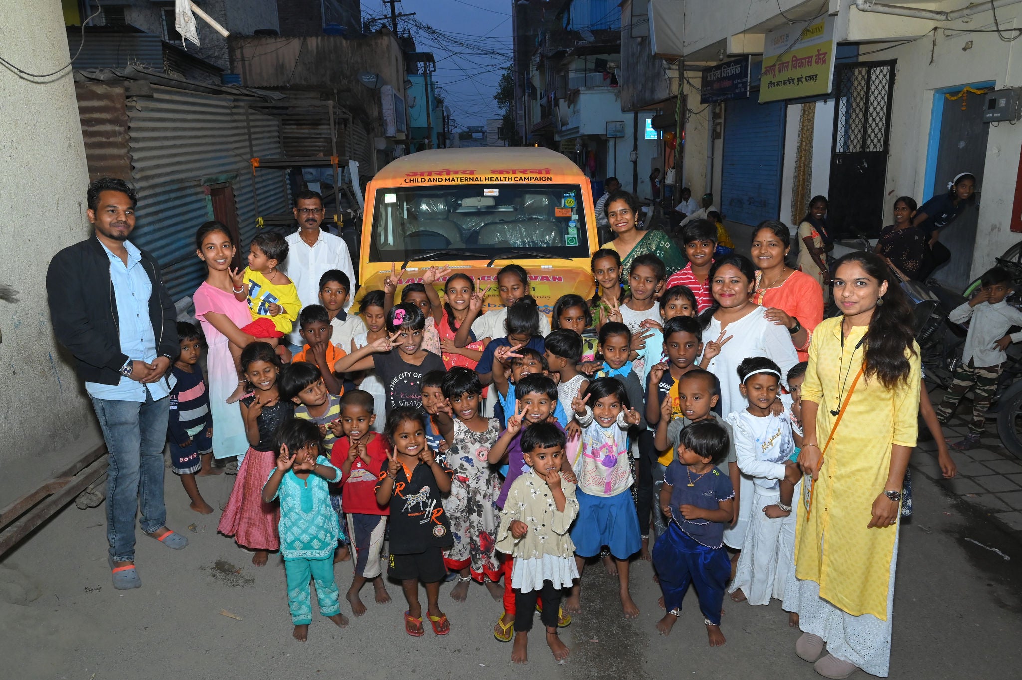 Sponsored van surrounded by children and adults