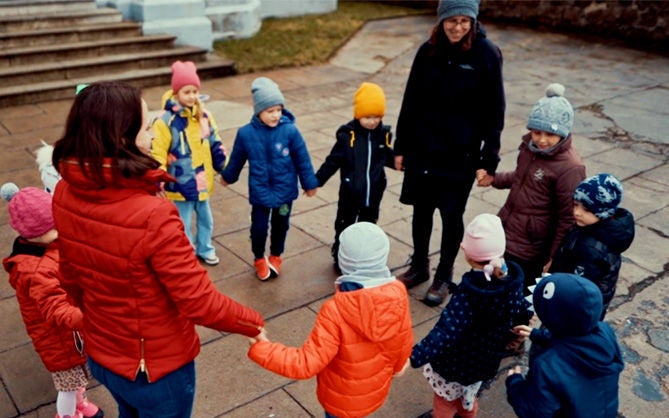 Circle of Ukrainian children at the aid center