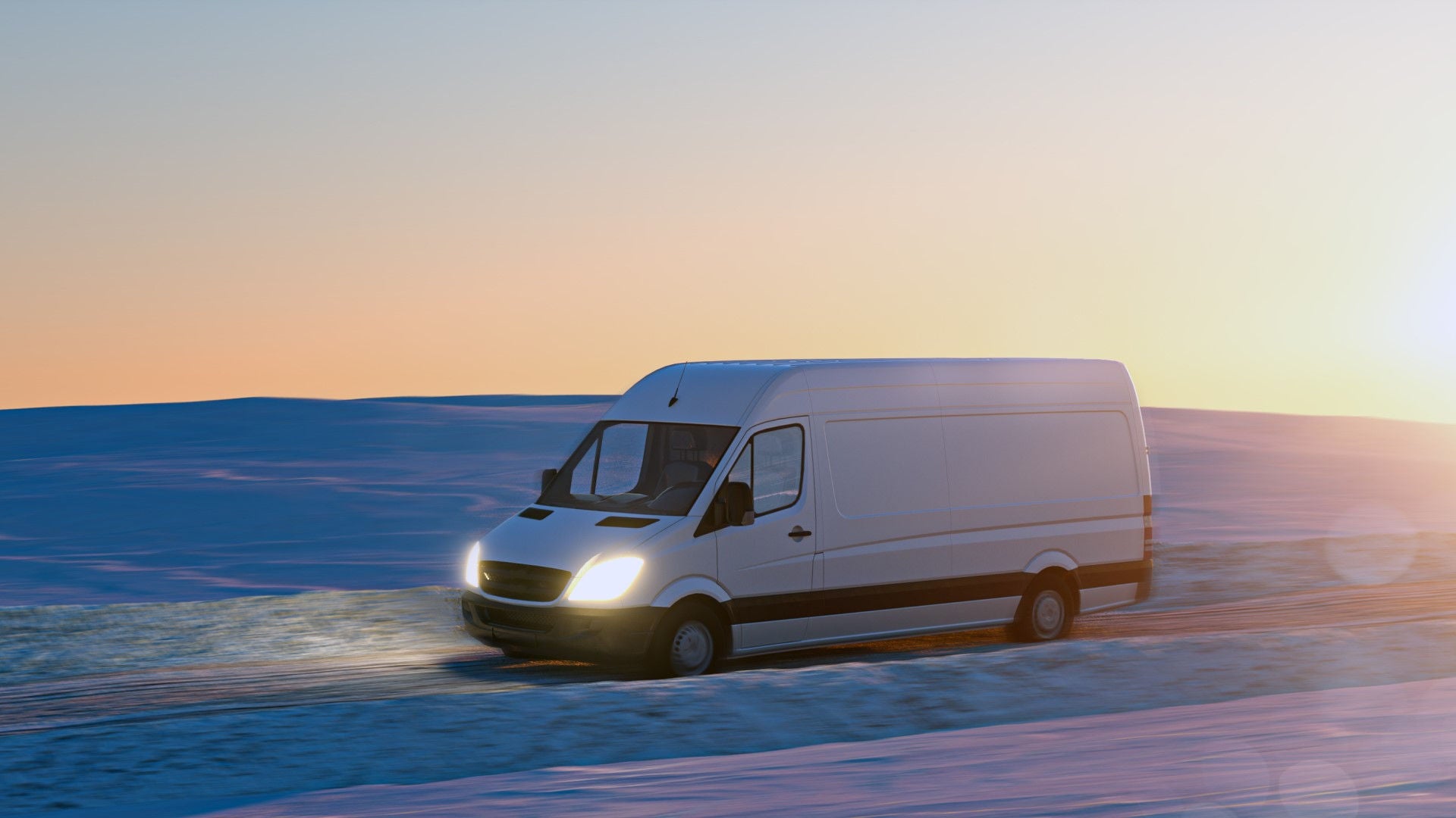 Light commercial vehicle driving on snow in winter landscape