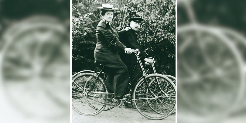 Two people riding their bikes