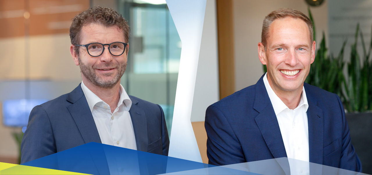 Corporate header featuring two senior executives in business attire with branded graphic overlay, for The Group leadership, governance and press pages.