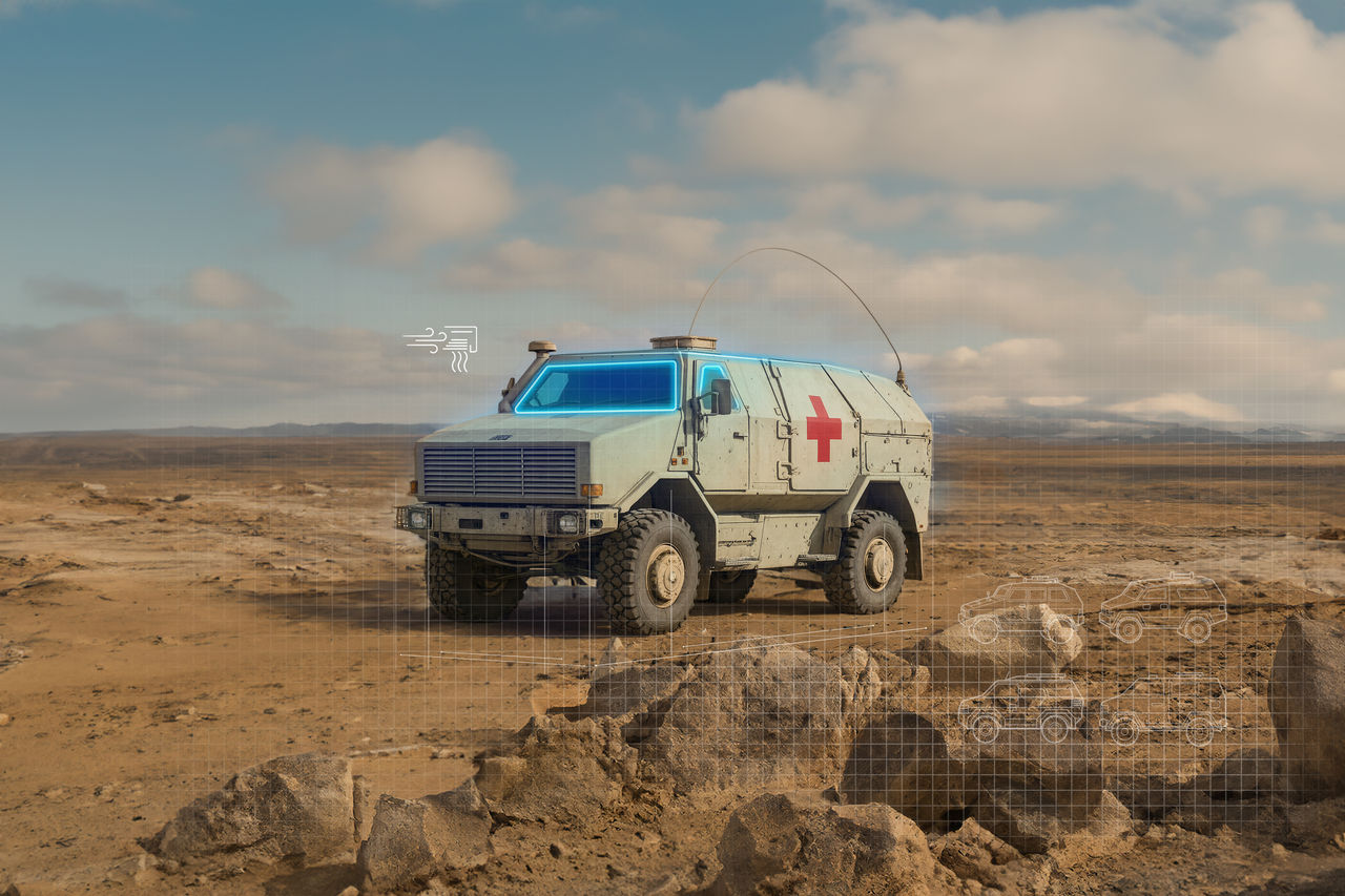 Armored off-road ambulance with reinforced chassis and high-clearance tires, showcasing integrated HVAC and thermal management for extreme mobility systems.
