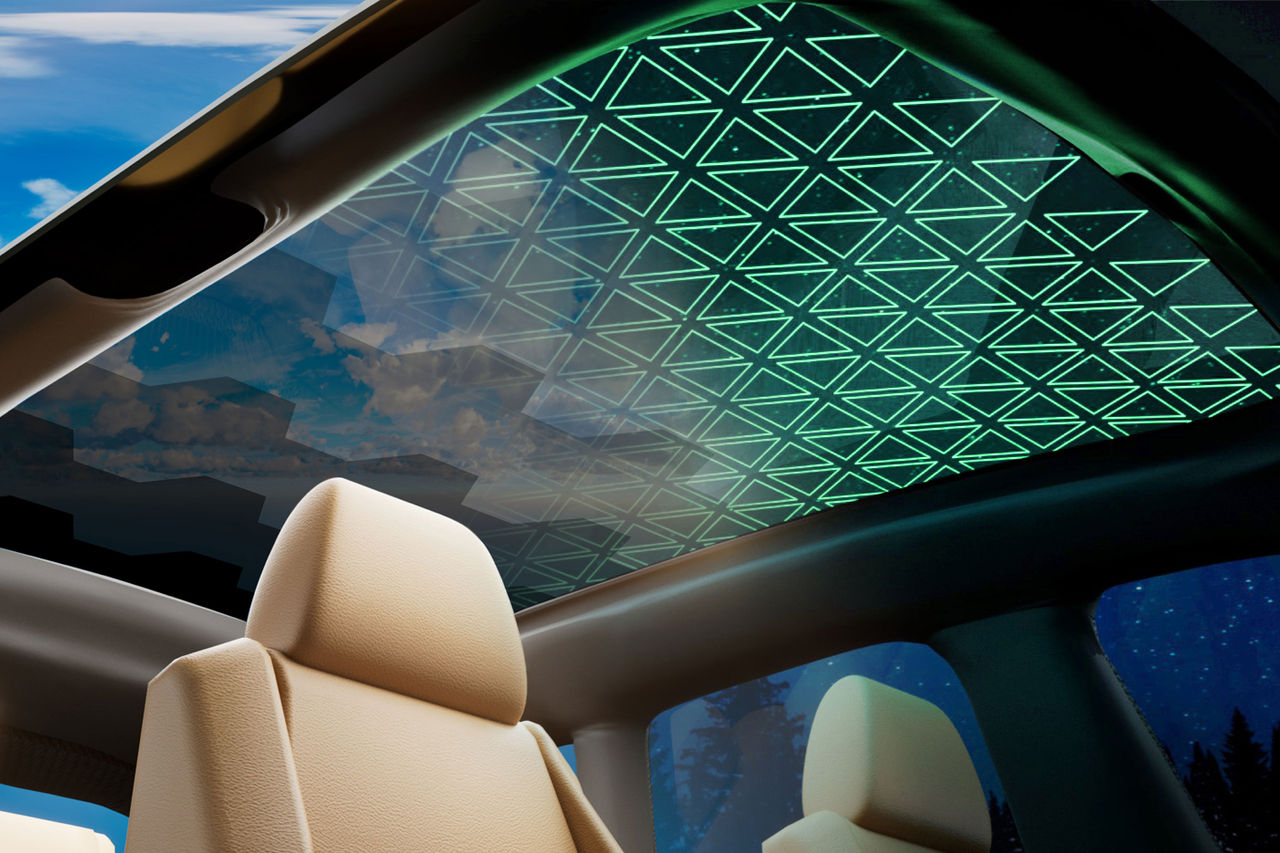 Panoramic glass roof with geometric ambient lighting over a beige cabin, for Webasto roof systems product pages showcasing advanced panoramic roof technology.