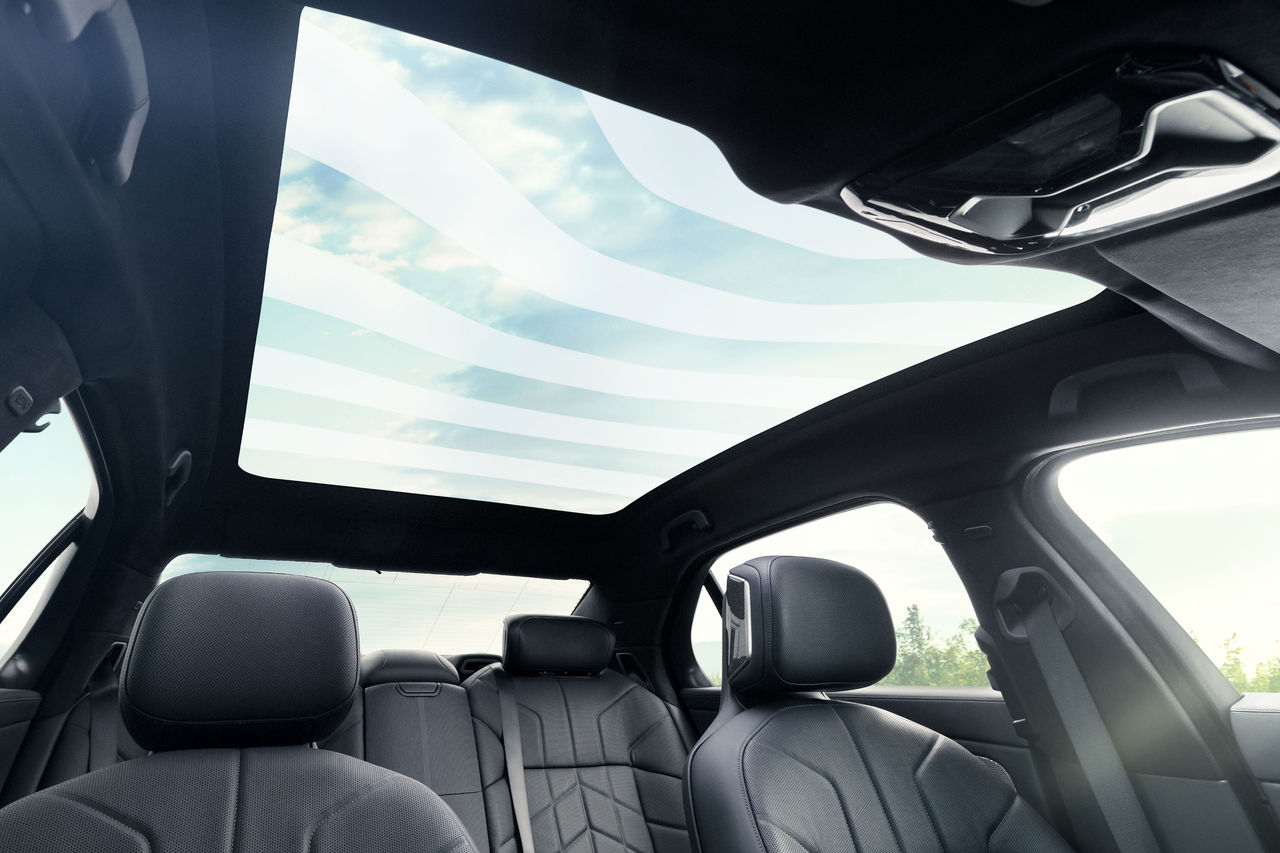 Panoramic glass roof interior showcasing Webasto roof system integration in a passenger car, hero header for products & solutions roof systems page.