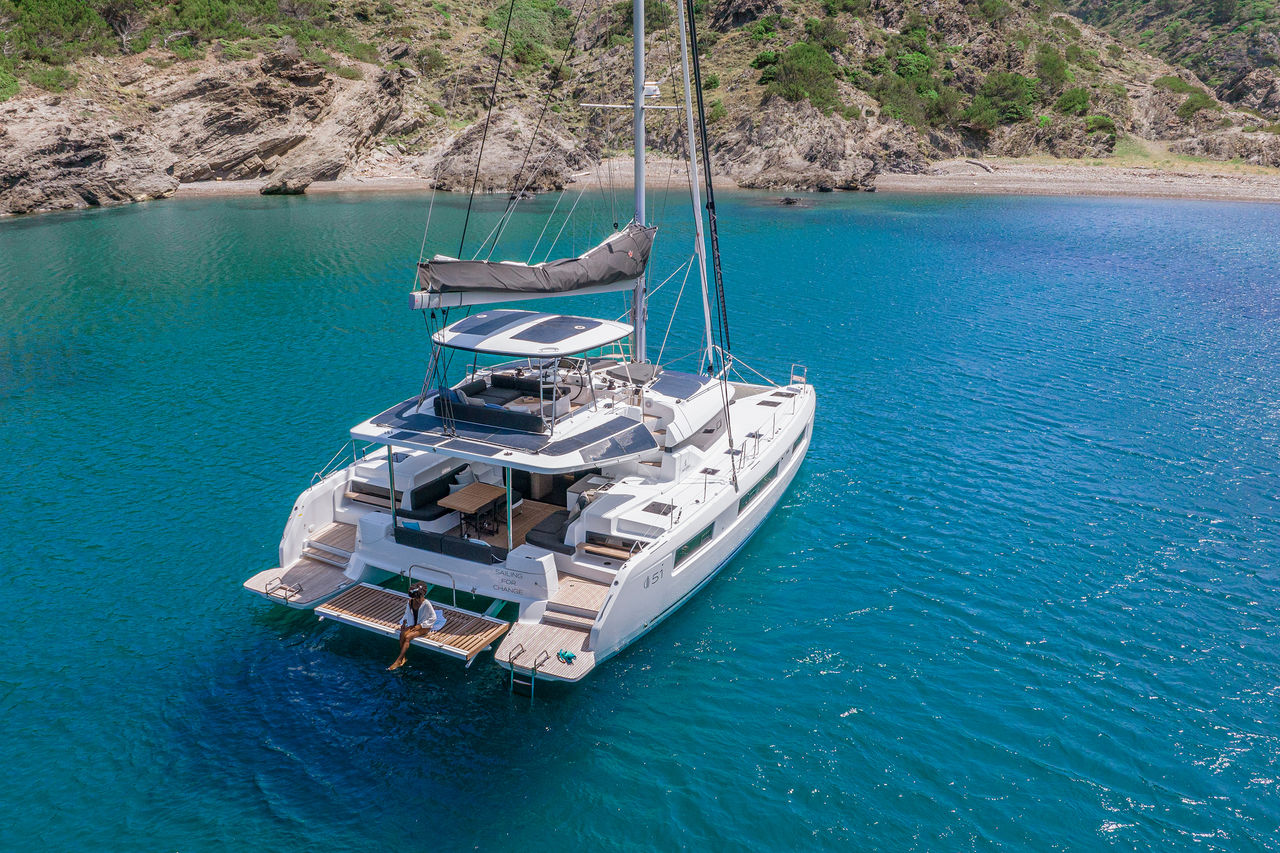 Sailing catamaran in turquoise bay illustrating Webasto marine solutions for boat electrification, battery and thermal management on vehicle solutions page.