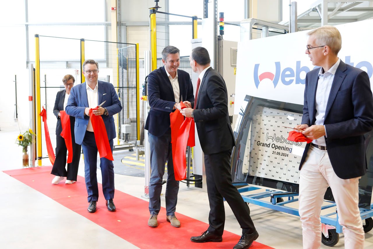 Webasto as system partner inaugurating a new production facility: ribbon-cutting at grand opening spotlighting roof systems manufacturing and plant expansion.