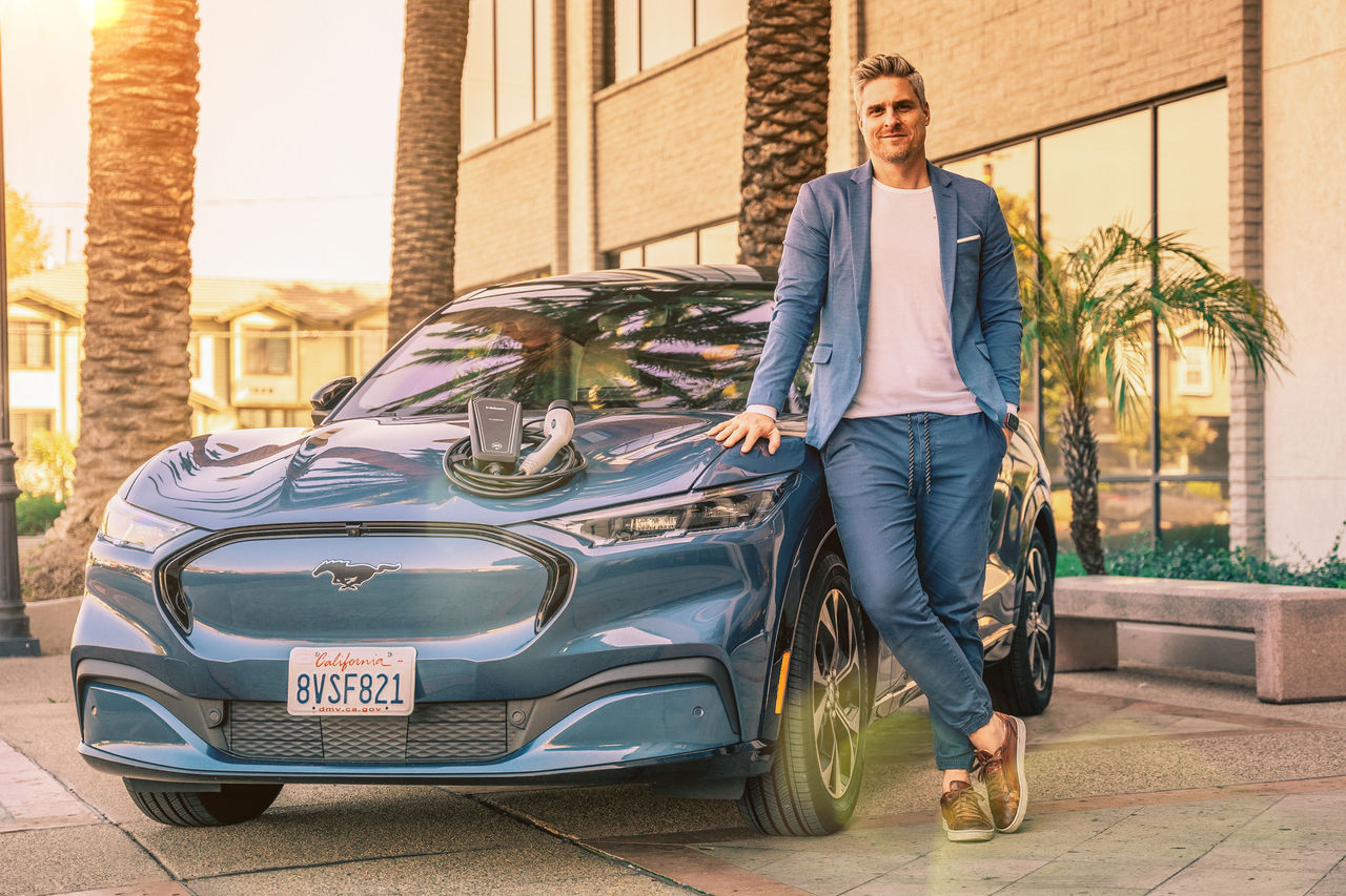 Vehicle electrification hero for vehicle solutions: passenger electric car with charging equipment, supporting Webasto as system partner for OEM electrification.