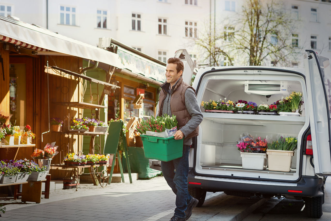 Man getting flowers from his light duty vehicle with transport refrigeration