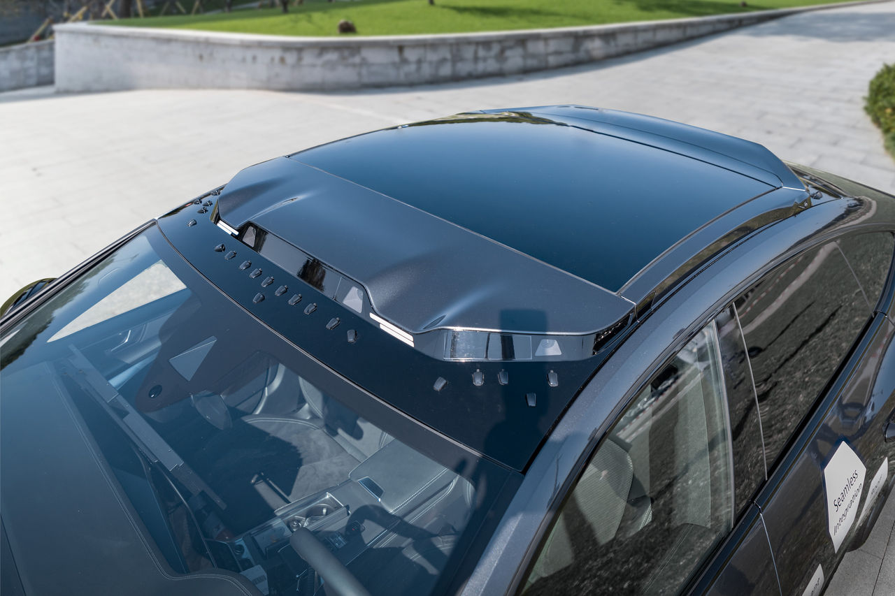 Flush panoramic roof with integrated module on passenger car, showcasing Webasto as system partner for seamless OEM roof integration and vehicle solutions.